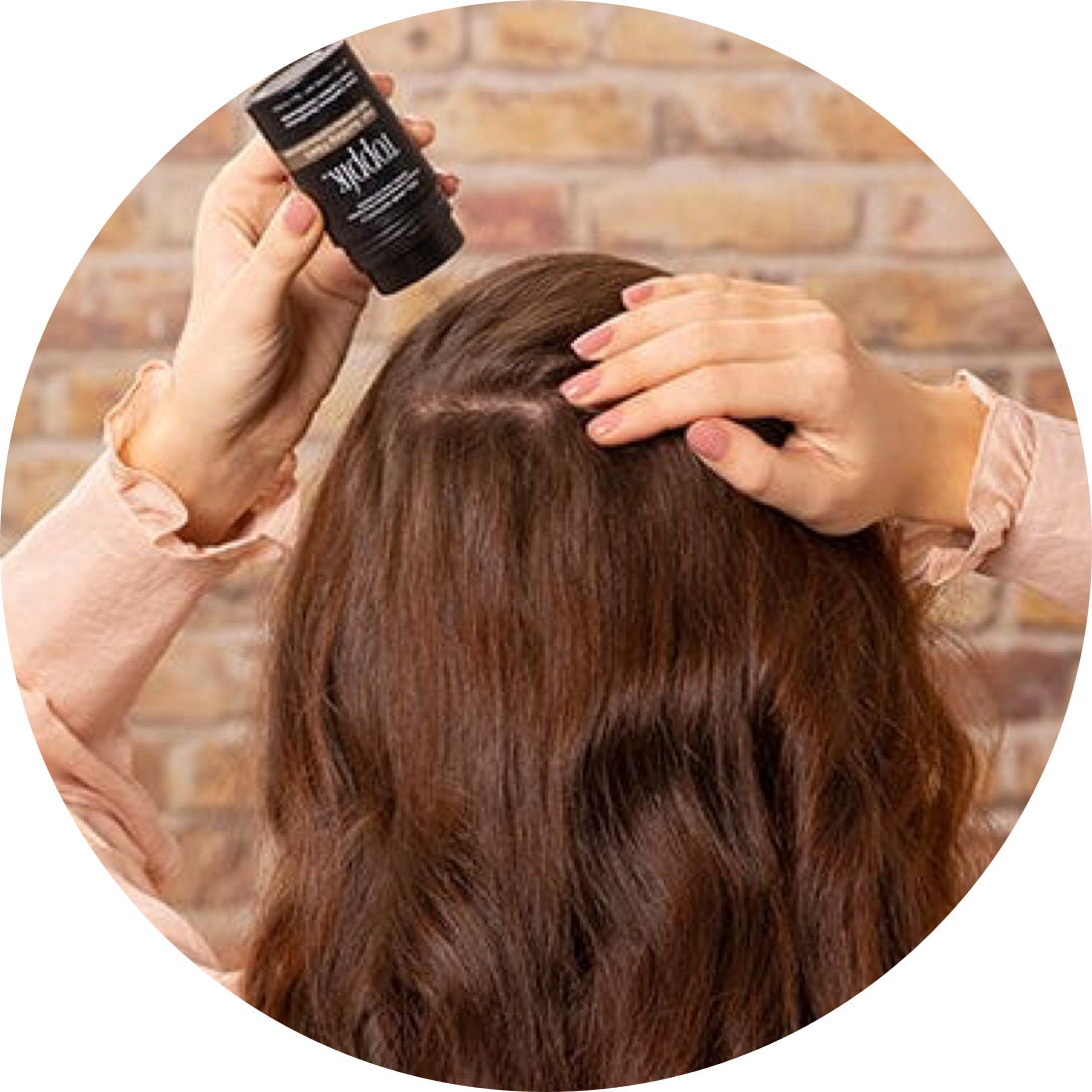 Female applying toppik product to back of head